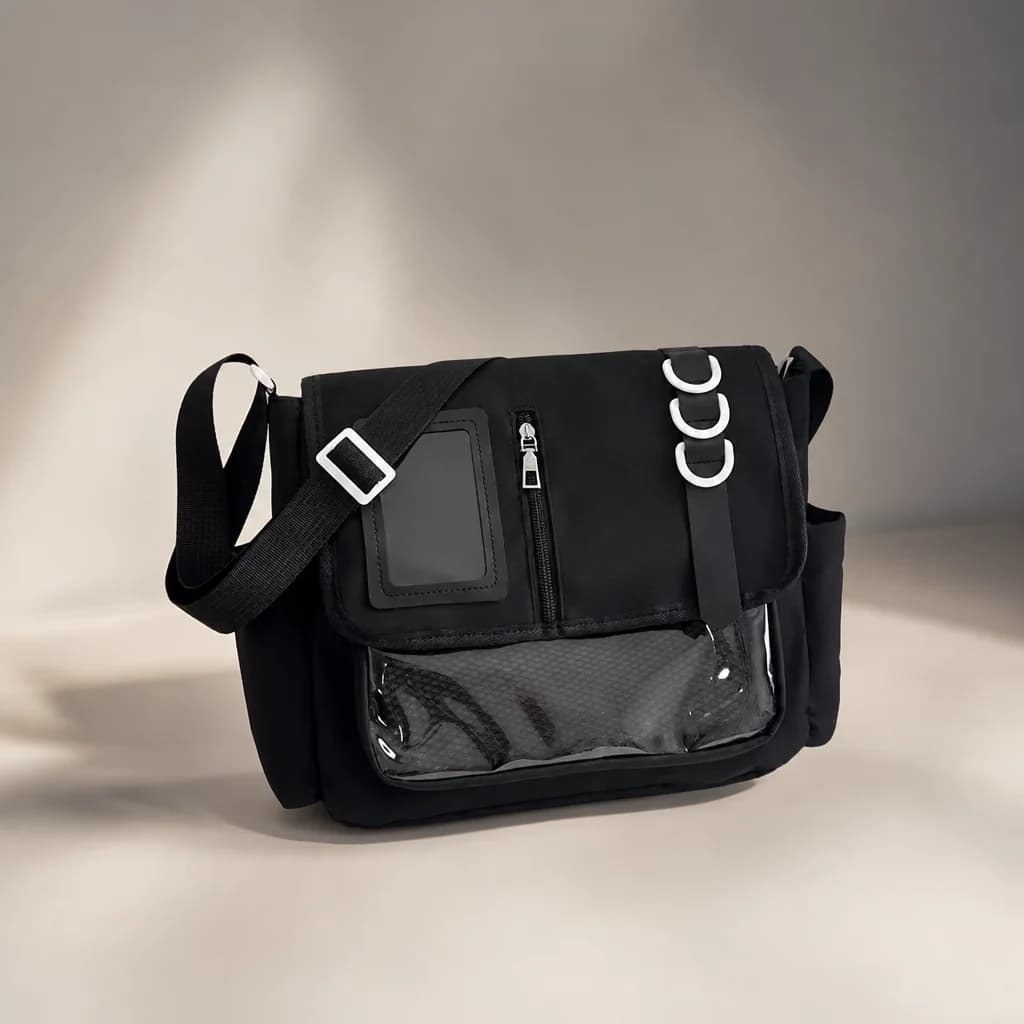 AI-enhanced editorial photograph of the black D-Ring Messenger on a warm ivory studio surface